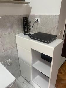 a white counter with a laptop on top of it at ALOHA apartment in Novi Pazar