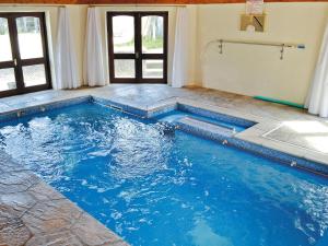 a swimming pool in a house with blue water at Anneth Lowen in Pentewan