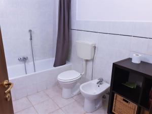 a bathroom with a toilet and a bath tub with a sink at Beautiful holiday home in Campagnano with private terrace in Musignano
