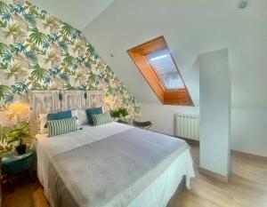 a bedroom with a large bed in a room at El Ático de Vigo in Vigo