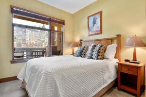 a bedroom with a large bed and a window at Ski In Ski Out Conde Nast and Forbes Award Winner Three Bedroom Pool Hot Tub Gym in Park City