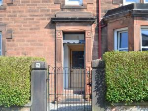 a gate in front of a brick building at Cardoness House in Dumfries