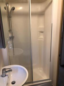 a bathroom with a shower and a sink at Classy caravan with ample space in Bembridge