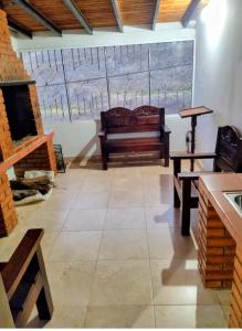 a room with two benches and a fireplace at Hospedaje Mérida in San Rafael