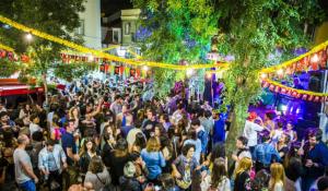 a crowd of people standing on a street at night at IN-Cascais Suite Deluxe com pátio privado in Cascais