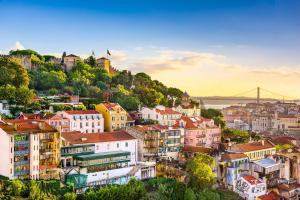 a city with buildings and a bridge in the background at IN-Cascais Suite Deluxe com pátio privado in Cascais