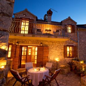 a patio with a table and chairs in front of a building at Villa Moro House in Milna