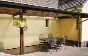 a patio with a table and chairs on it at Pet Friendly Home In Brekendorf With Kitchen in Brekendorf