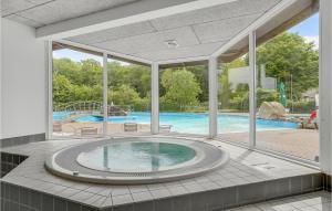an indoor pool with a hot tub in a house at Pet Friendly Home In Fredericia With Wifi in Fredericia