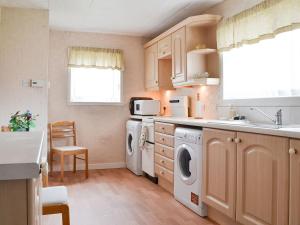 a kitchen with a washer and dryer at Moray Cottage in Wick