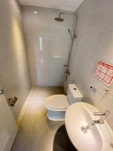 a small bathroom with a toilet and a sink at Victoria's Bed & Breakfast in Puerto Galera +30 photos