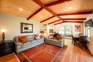 Sala de estar con 2 sofás y mesa en Criffel Bluffs Cottage, en Wanaka