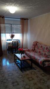 a living room with a couch and a table at Apartamento Guardamar 1D Estándar in Guardamar del Segura