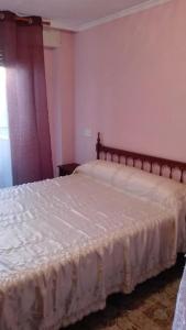 a bedroom with a bed with a white bedspread at Apartamento Guardamar 1D Estándar in Guardamar del Segura