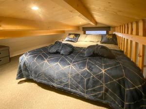 a bedroom with a large bed in a cabin at The Nab in Carlton