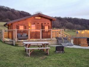 a wooden cabin with a picnic table in front of it at The Nab in Carlton