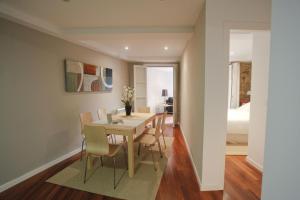 a dining room with a table and chairs and a bedroom at Catedral Site by Como en Casa in Santiago de Compostela