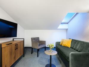 a living room with a couch and a chair at Old Market Residence in Krakow