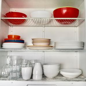 a shelf with plates and bowls and other dishes at University Retreat-near U Of U, Hospital,downtown in Salt Lake City