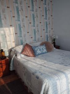 a bed with two pillows on it in a bedroom at Casa viña del mar con piscina in Viña del Mar