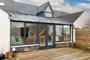 an extension of a conservatory with a roof at Trellys Hyfryd - cottage in Fishguard