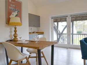 a dining room table with two chairs and a lamp at Staveley Park Studio - Uk33716 in Staveley