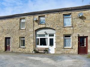 a stone building with a white door and windows at Number 3 - Uk33333 in Newby