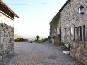 an alley between two stone buildings next to a building at Oak Barn Cottage in Trefonen