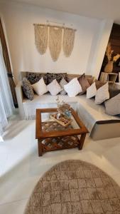 a living room with a couch and a coffee table at Chaweng Beautiful Studio. in Koh Samui  +10 photos