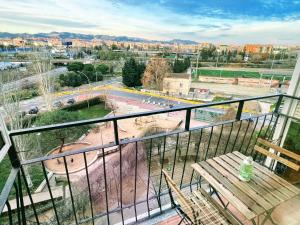 a balcony with a bench and a view of a park at Magnifico Apartamento Barca 4 in Sant Adria de Besos