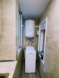 a bathroom with a washer and dryer in a room at Magnifico Apartamento Barca 4 in Sant Adria de Besos +14 photos