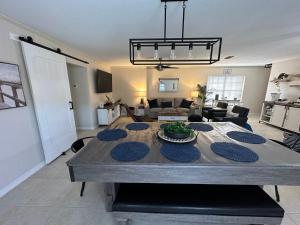 a living room with a dining table and a living room at Three Treasures Beach House in New Smyrna Beach +3 photos