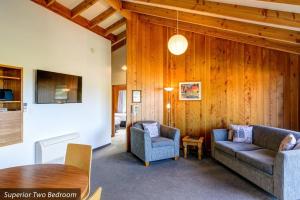 a living room with a couch and a table at Unit 10 Kaiteri Apartments and Holiday Homes in Kaiteriteri