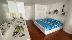 a bedroom with a bed and a table in it at Sky Beach Beachfront Pattaya in Pattaya North +28 photos
