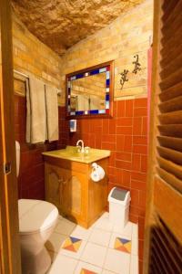 a bathroom with a toilet and a sink at The Underground Motel in Coober Pedy