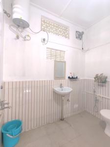 a bathroom with a sink and a toilet at Gianna Homestay in Jorhāt