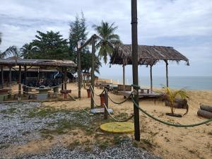 a resort on the beach with aiki at D'RinduVillage Homestay in Marang