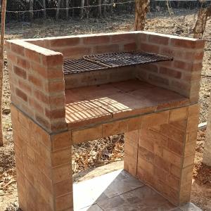 a barbecue grill sitting on top of a brick oven at La Casa de Thurys in Pedasí Town