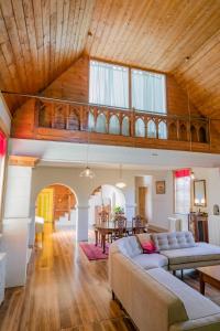 a living room with two couches and a wooden ceiling at Abbey on Main - Unique heritage listed property overlooking the Huon River in Franklin