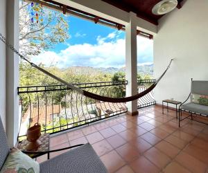 a living room with a hammock on a balcony at Terramaya Boutique Hotel in Copan Ruinas