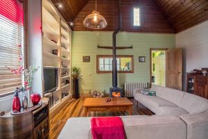 a living room with a couch and a fireplace at Abbey on Main - Unique heritage listed property overlooking the Huon River in Franklin