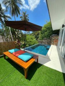 Villa Sumalee Sea' View في كوه ساموي: جلسة مع مظلة بجانب المسبح