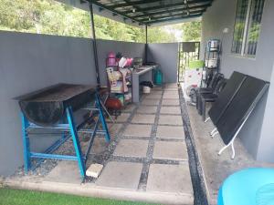 a covered patio with a table and a bench at My Pool House in Alor Setar