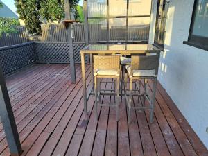 a table and two chairs sitting on a deck at Richmond Central 3bdrm House sleeps 7 in Richmond