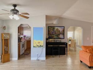 a living room with a piano and a kitchen at Sun Angel House #1 Pahrump in Pahrump