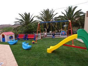 une aire de jeux avec un toboggan et une balançoire dans l'établissement Asterion Apartments, à Panormos Rethymno