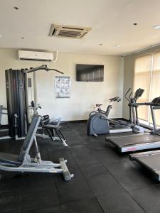 a gym with several treadmills and exercise bikes at Fully furnished 1 BR Condo unit in Manila