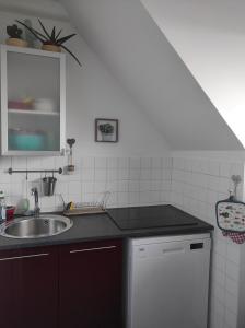 a kitchen with a sink and a counter top at La Belle Vie Ouistreham Riva Bella Résidence Hastings in Ouistreham