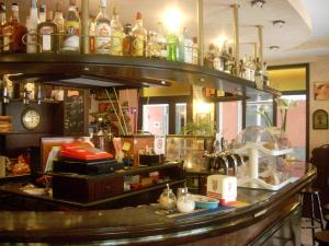 a bar with a lot of bottles on top of it at Hotel Corallo in Moneglia