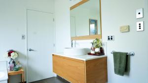 a bathroom with a sink and a mirror at Vines on Bannockburn in Cromwell